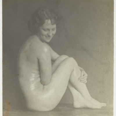 Untitled [Nude Woman, Crossed Legs, Smiling]
