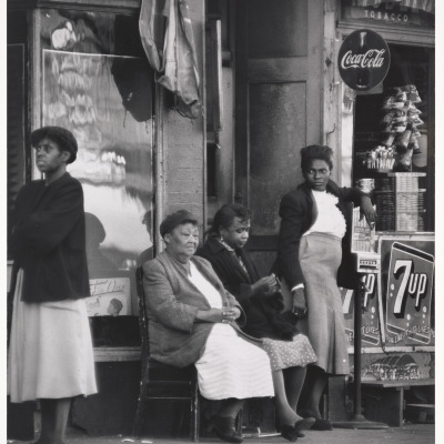 Women Sitting by Storefront in Harlem, NYC